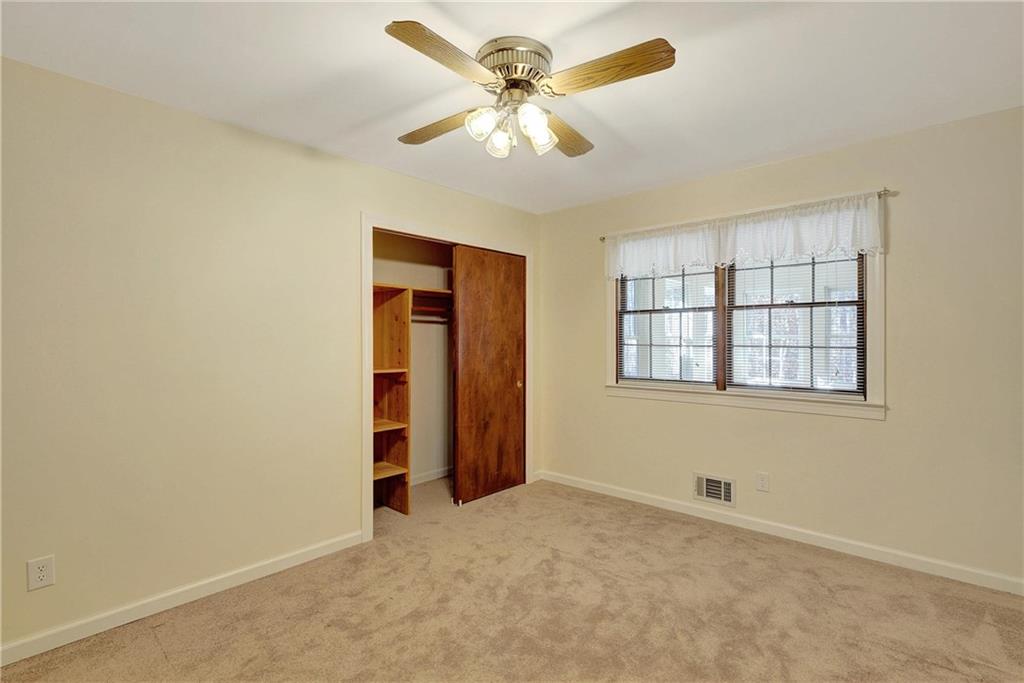 10185 Henry Mill Road Chattahoochee Hills, GA 30213 - Photo 7 of 41 an empty room with chandelier fan and windows