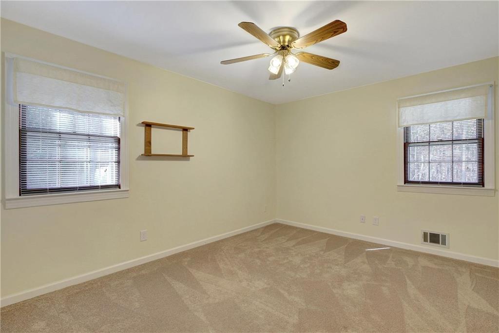 10185 Henry Mill Road Chattahoochee Hills, GA 30213 - Photo 8 of 41 an empty room with windows and cabinet