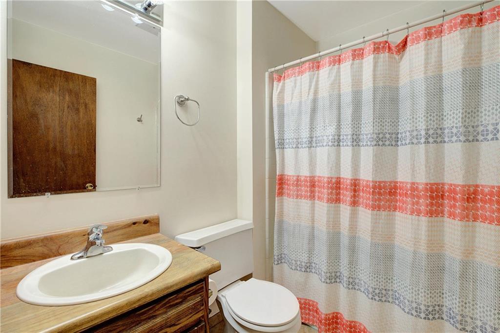 10185 Henry Mill Road Chattahoochee Hills, GA 30213 - Photo 10 of 41 a bathroom with a sink a toilet and shower curtain