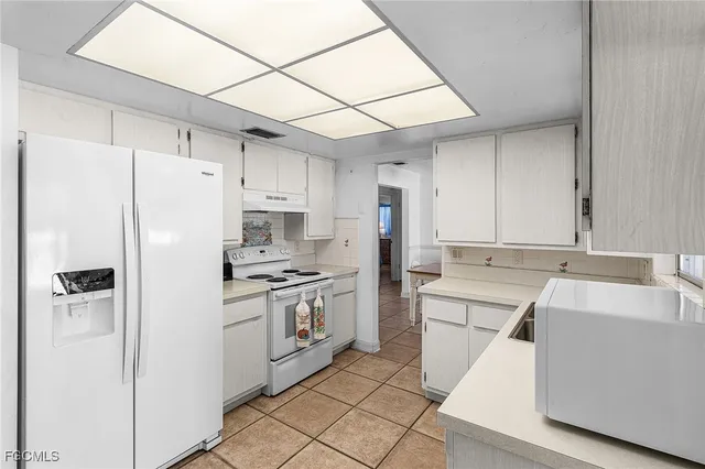 a kitchen with stainless steel appliances a refrigerator sink and stove