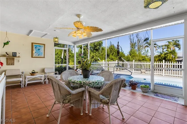 a view of a dining room with furniture one side kitchen view and wooden floor