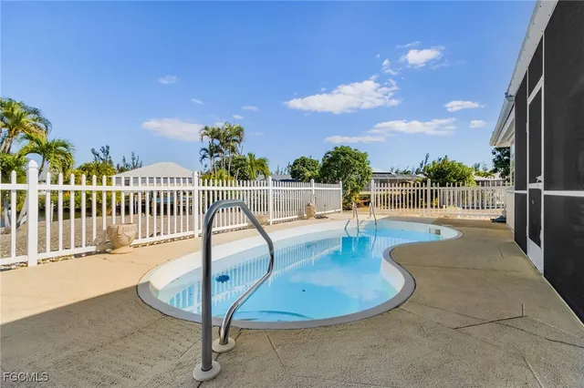 a view of a swimming pool with a lounge chair
