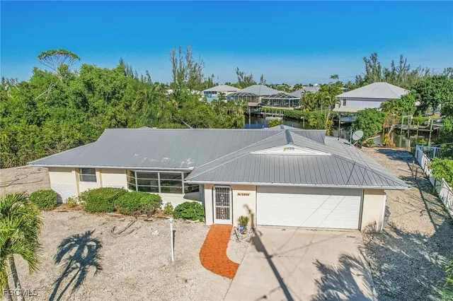 a aerial view of a house with a yard and sitting area