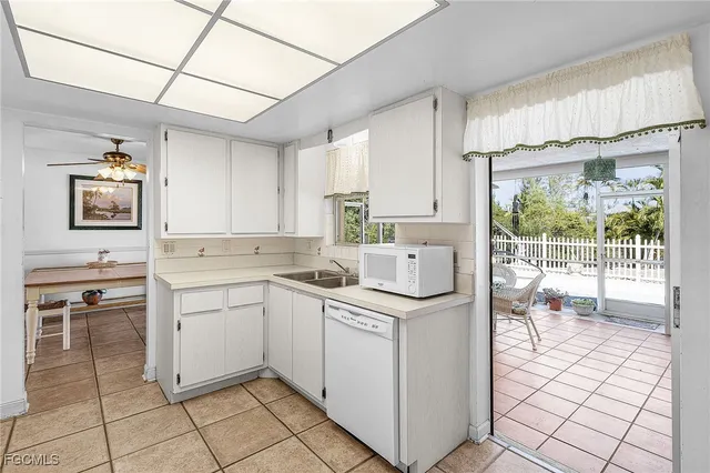 a kitchen with a stove a sink and a refrigerator