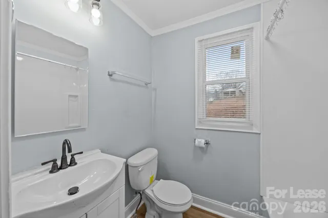 a bathroom with a sink toilet and a mirror