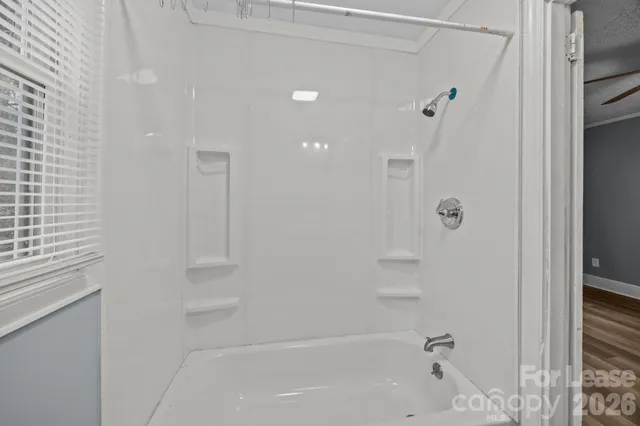a bathroom with a bathtub and a shower