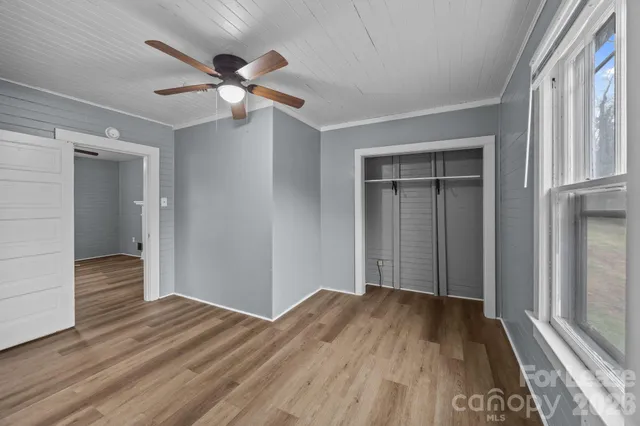 wooden floor in an empty room with a window