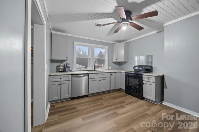 a kitchen with a stove cabinets and a refrigerator