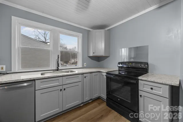 a kitchen with a sink stove and cabinets