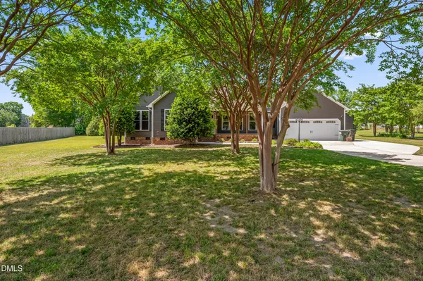 a house with huge green field in front of it