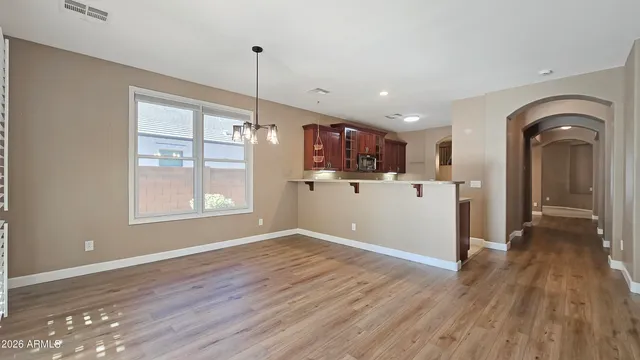 a view of a kitchen with wooden floor and a window
