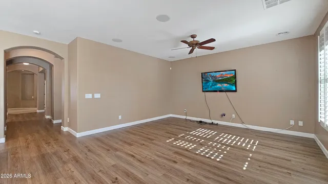 a view of an empty room with wooden floor