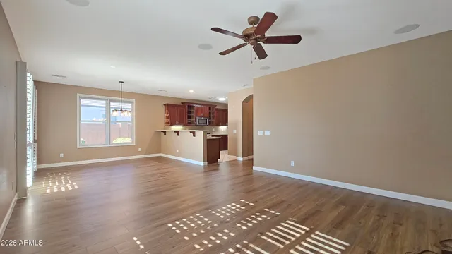 a view of a kitchen with a sink refrigerator and wooden floor