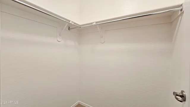 an empty room with a window and ceiling fan