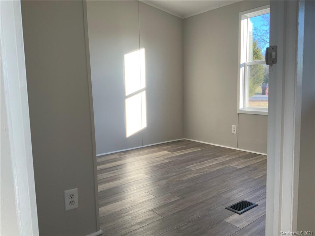 115 Riting Road, Unit 58 Salisbury, NC 28147 - Photo 11 of 23 an empty room with wooden floor and windows