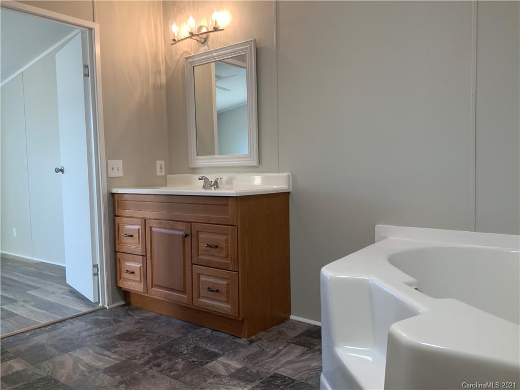 115 Riting Road, Unit 58 Salisbury, NC 28147 - Photo 18 of 23 a bathroom with a tub sink and mirror