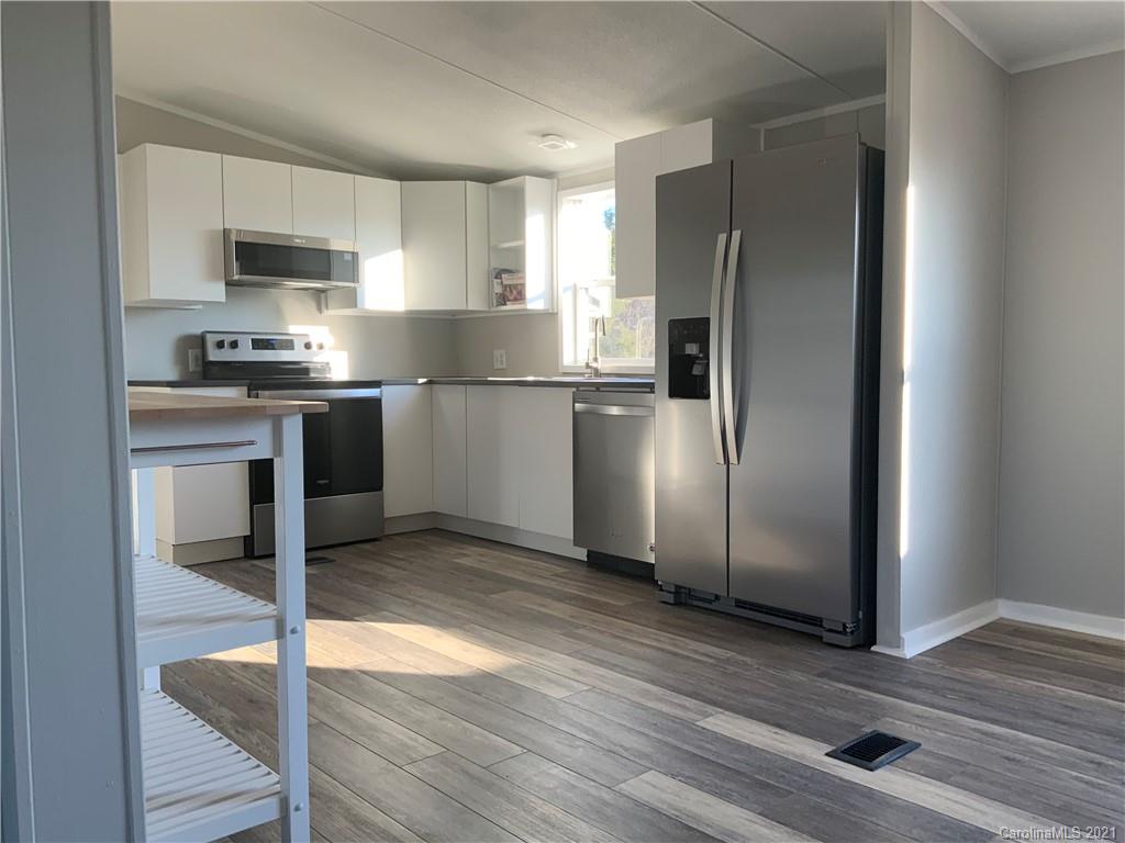 115 Riting Road, Unit 58 Salisbury, NC 28147 - Photo 5 of 23 a kitchen with stainless steel appliances granite countertop a refrigerator and a stove top oven