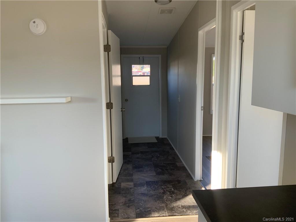 115 Riting Road, Unit 58 Salisbury, NC 28147 - Photo 8 of 23 a view of a hallway with wooden floor and a bathroom