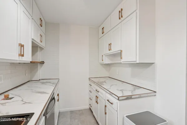 a utility room with cabinets washer and dryer