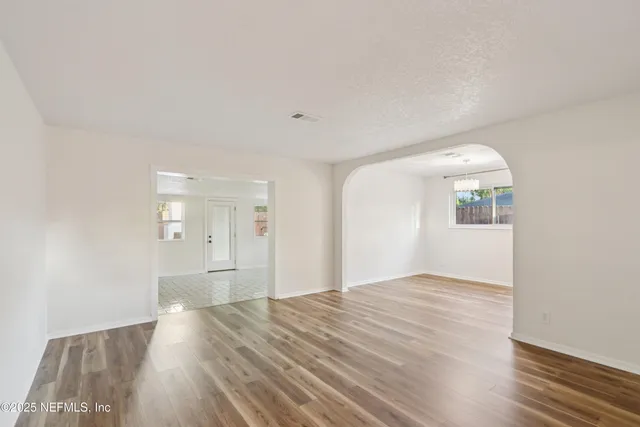 a view of empty room with wooden floor