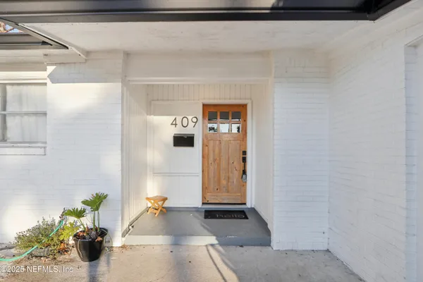 a hallway with a potted plant in front of it