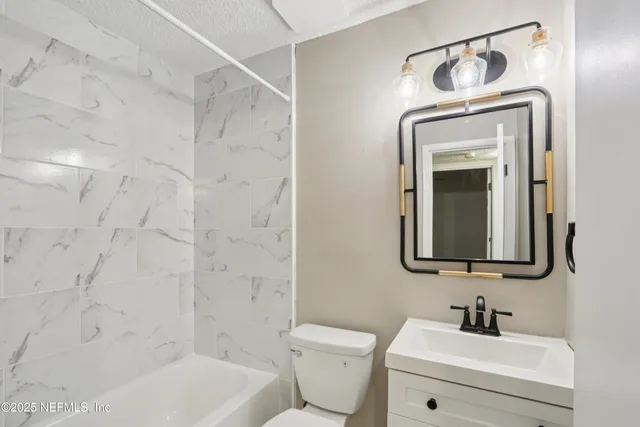 a bathroom with a toilet sink and shower