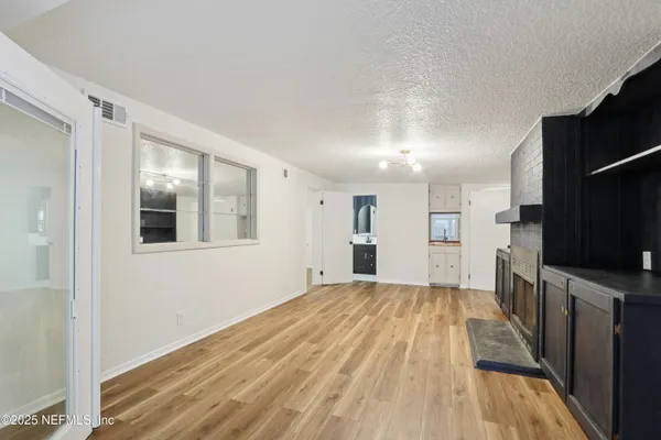 a view of a kitchen with wooden floor and a sink