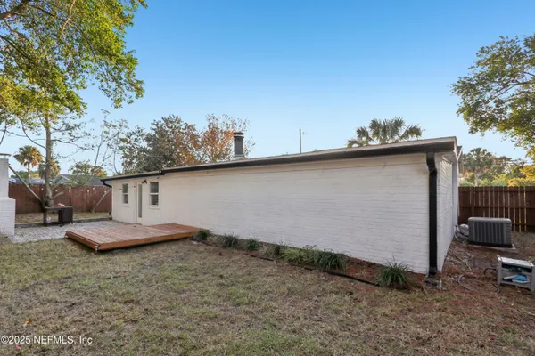 a backyard of a house with a table and chair
