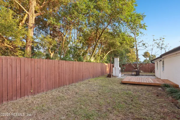 a backyard of a house with a tree