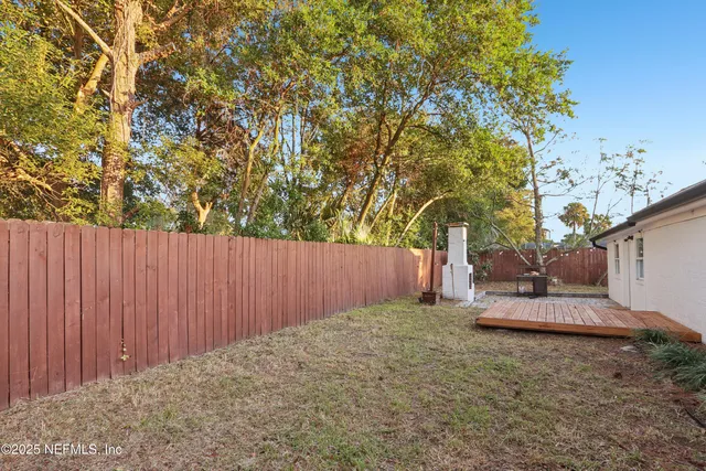 a backyard of a house with a tree