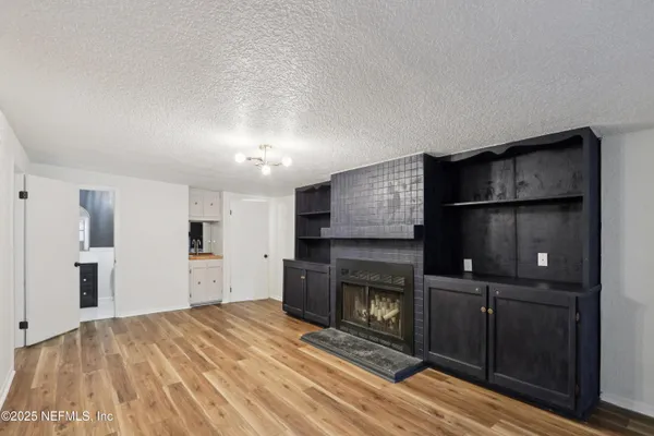 a living room with a fireplace furniture and a flat screen tv