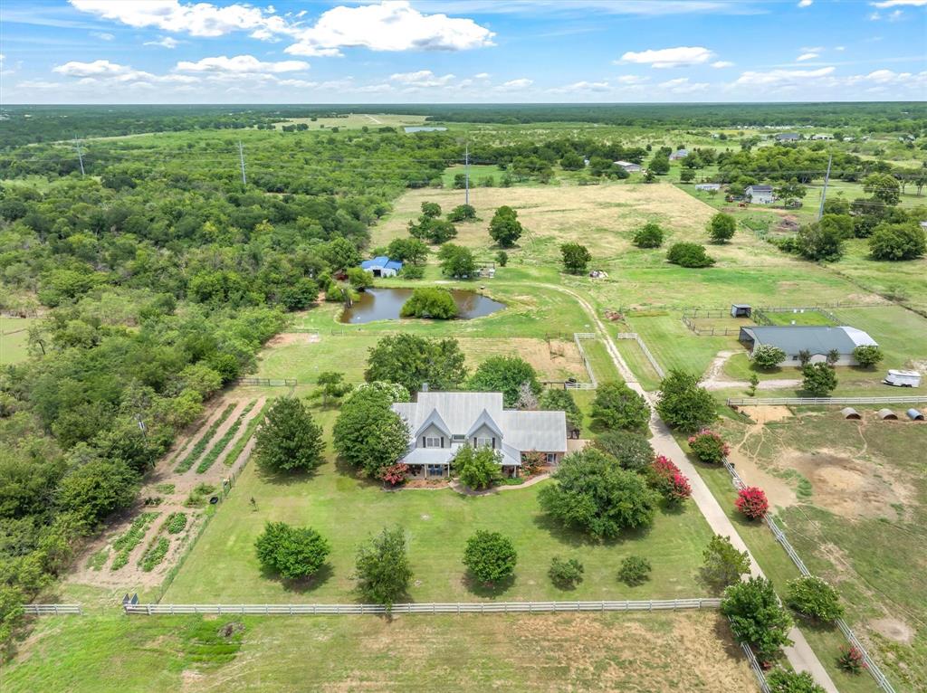 2141 Poetry Road Royse City, TX 75189 - Photo 9 of 38 Home in foreground, horse barn with apartment to right, and equipment or hay barn in back.