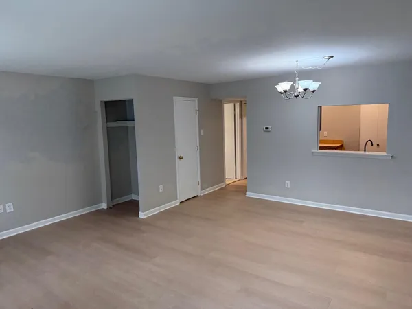 an empty room with a mirror and a lamp