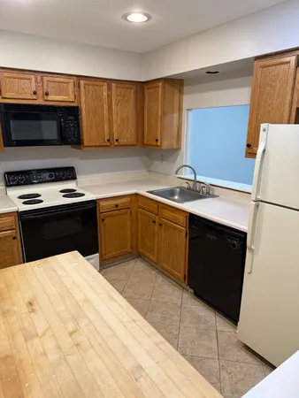 a kitchen with a sink appliances and cabinets