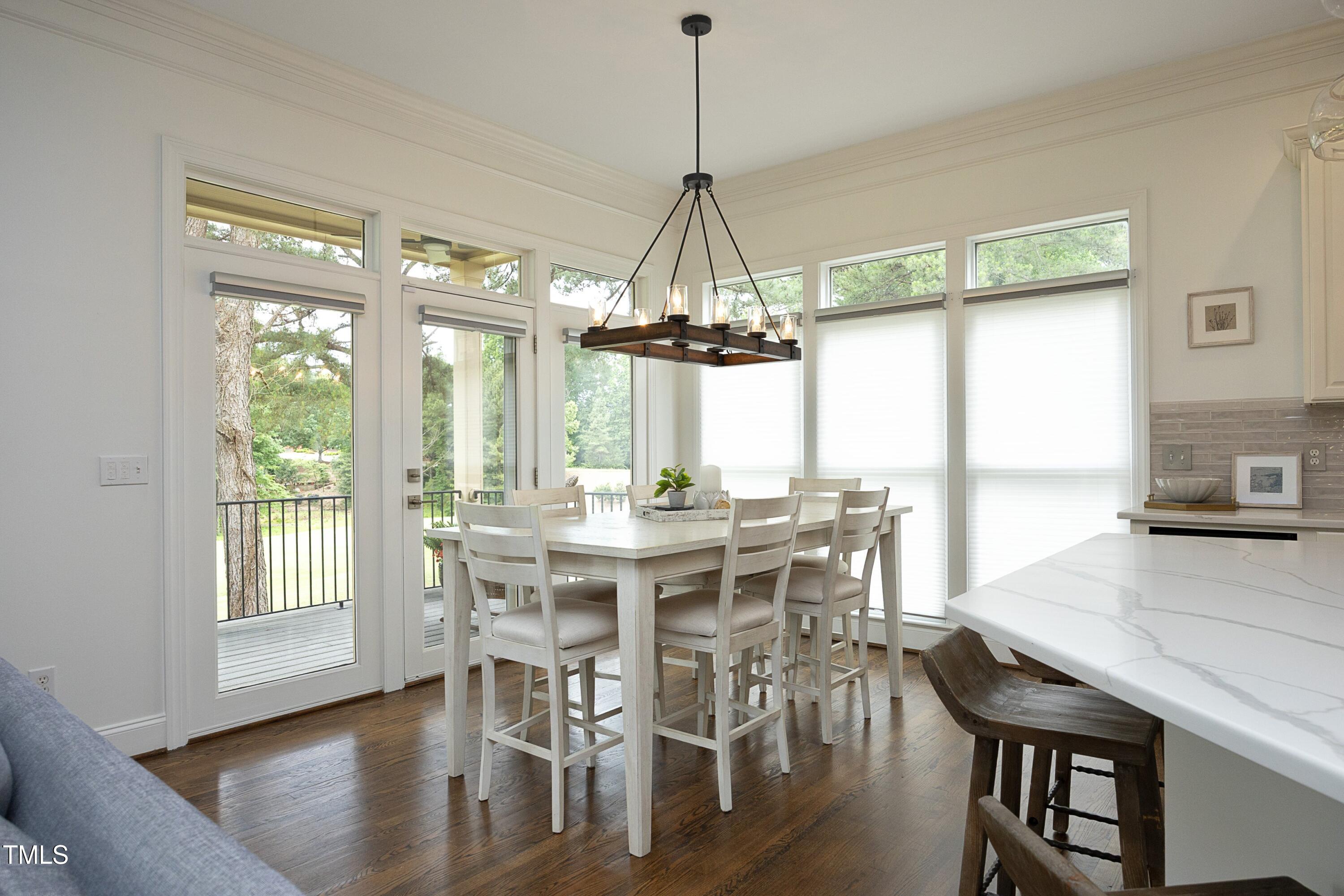 2800 Charleston Oaks Drive Raleigh, NC 27614 - Photo 11 of 53 a dining room with furniture a chandelier and wooden floor