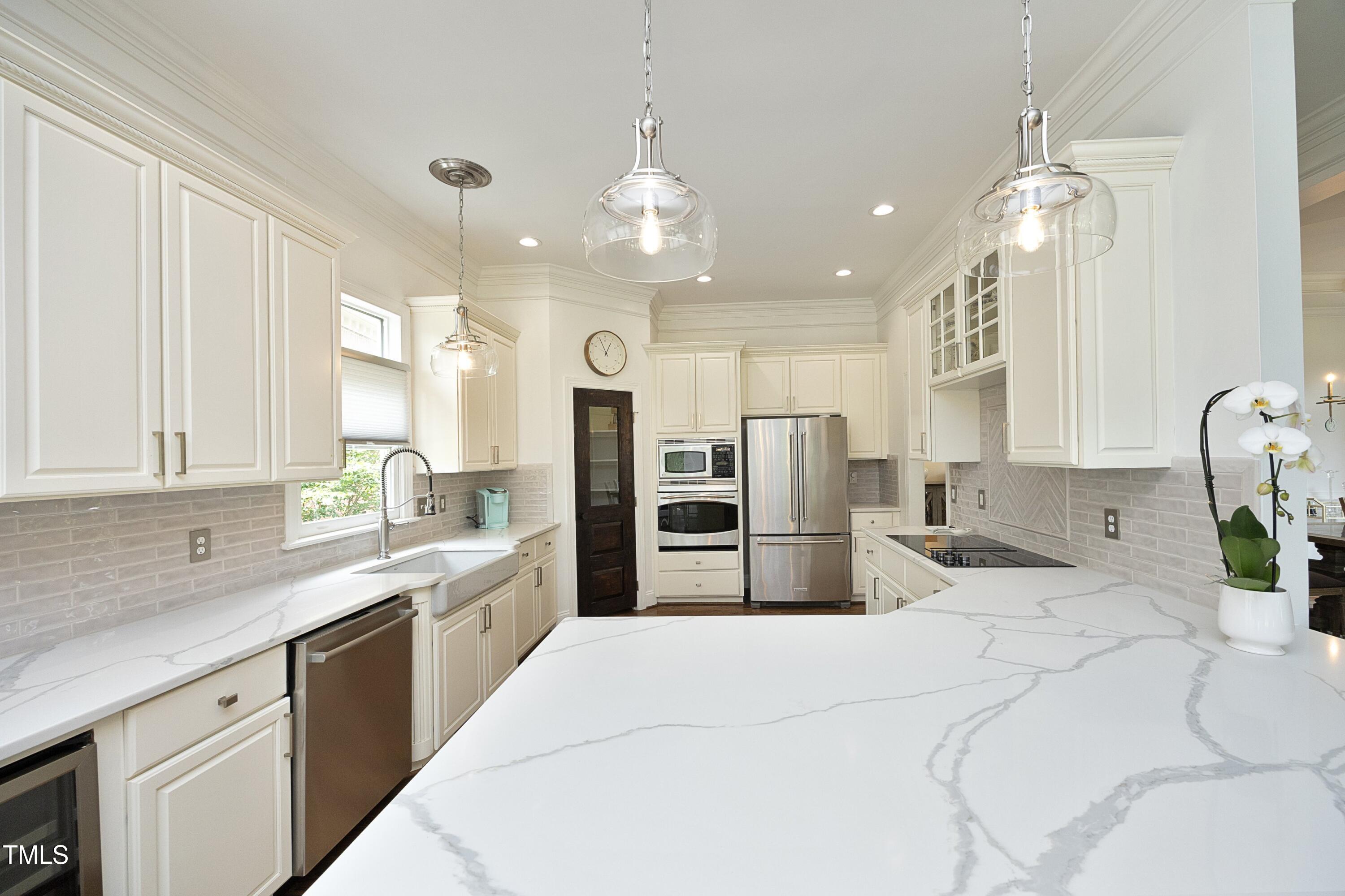 2800 Charleston Oaks Drive Raleigh, NC 27614 - Photo 13 of 53 a kitchen with stainless steel appliances kitchen island granite countertop a sink refrigerator and cabinets