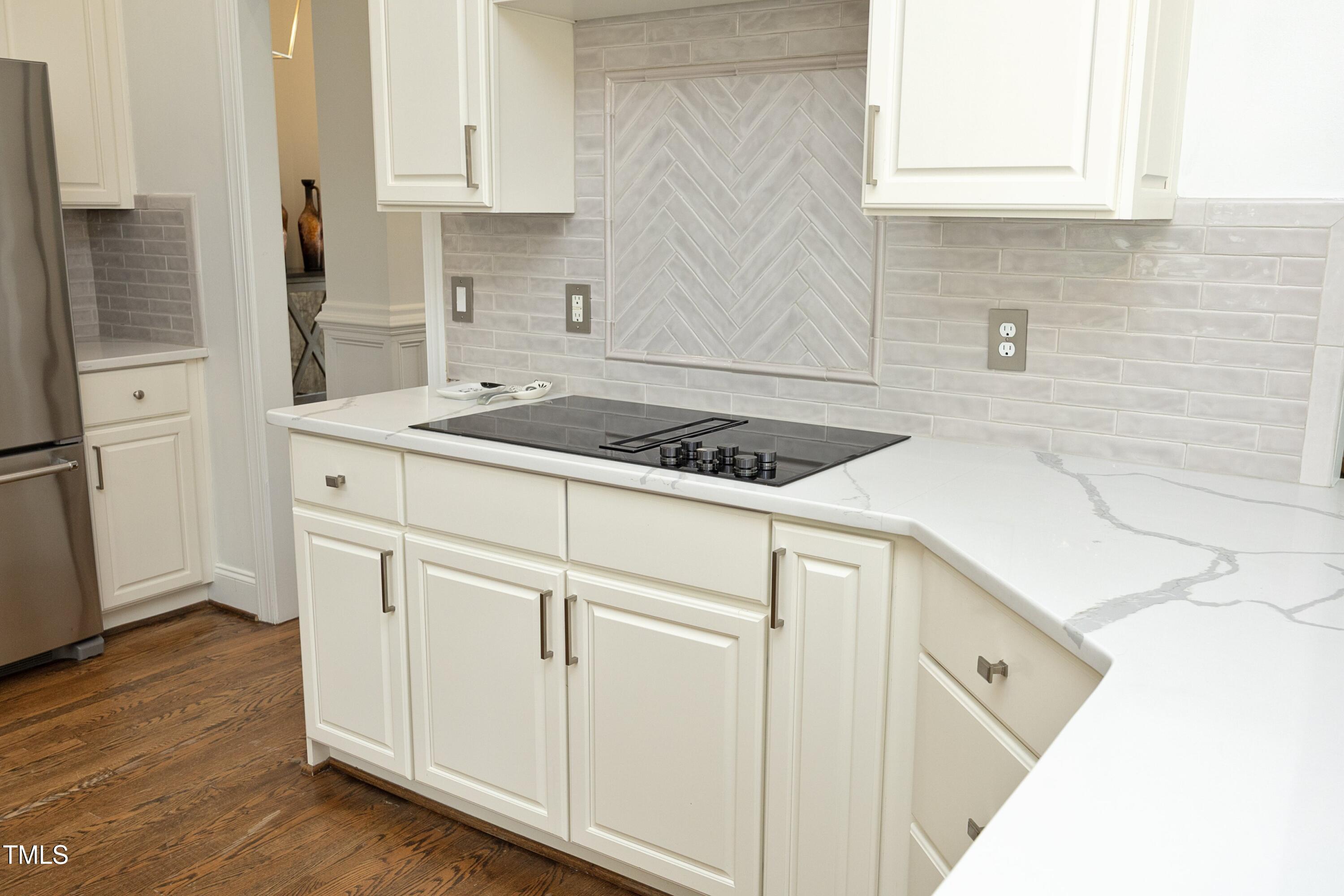 2800 Charleston Oaks Drive Raleigh, NC 27614 - Photo 15 of 53 a kitchen with white cabinets and white appliances