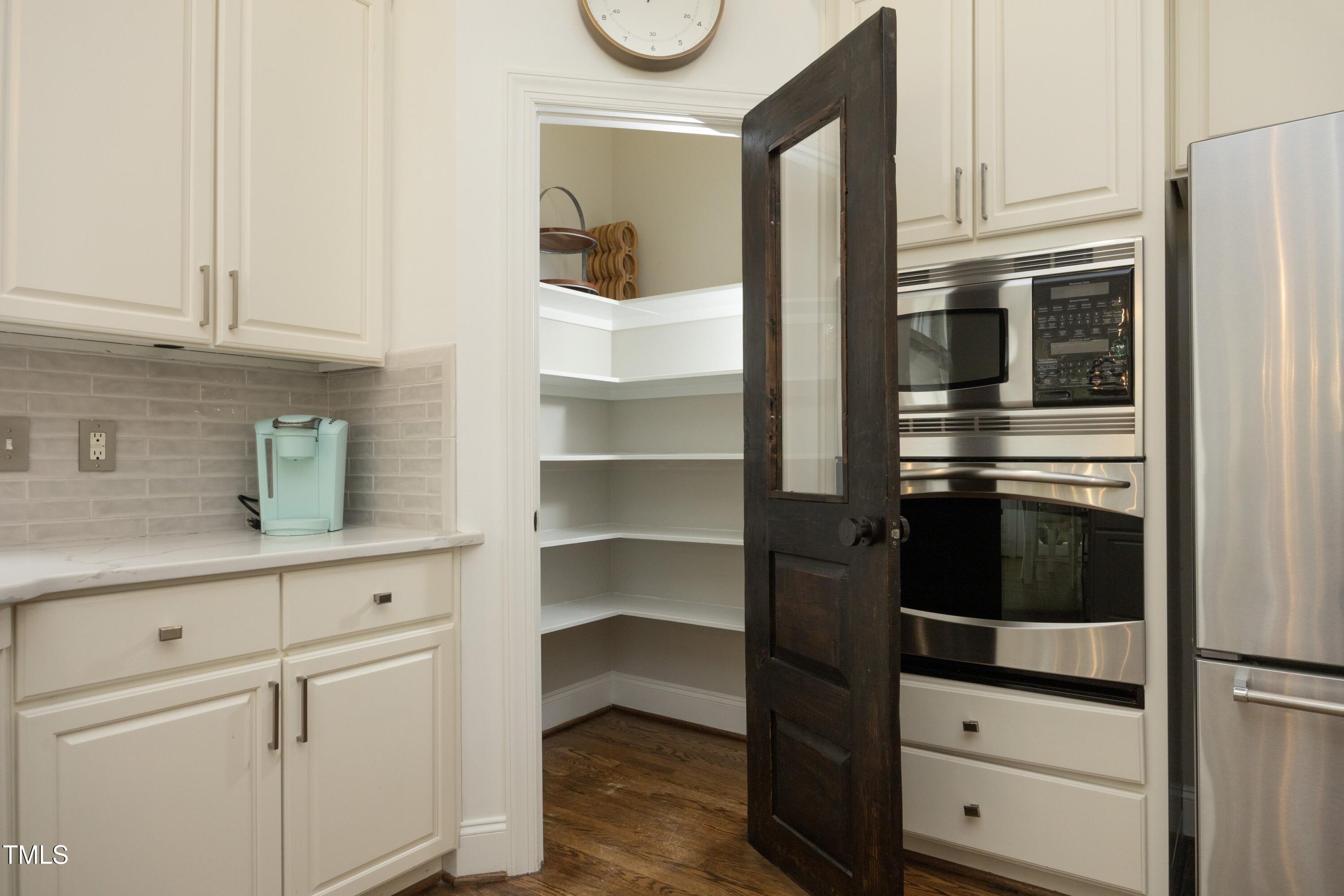 2800 Charleston Oaks Drive Raleigh, NC 27614 - Photo 16 of 53 a kitchen with white cabinets and black appliances