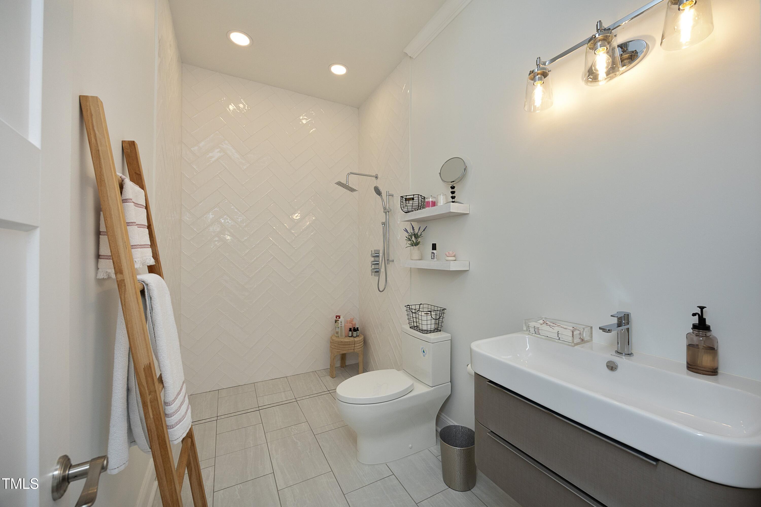 2800 Charleston Oaks Drive Raleigh, NC 27614 - Photo 22 of 53 a bathroom with a sink a toilet and shower