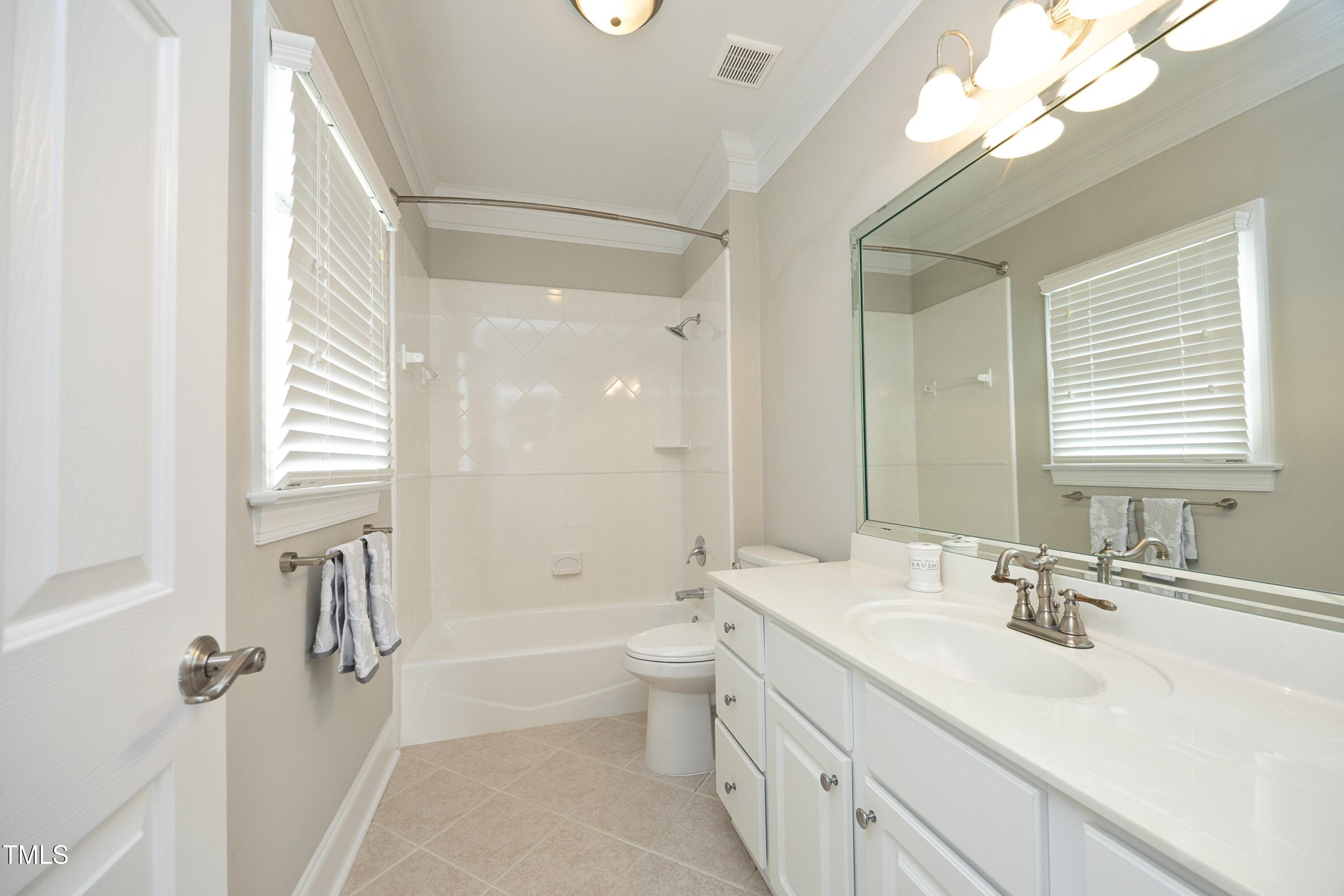 2800 Charleston Oaks Drive Raleigh, NC 27614 - Photo 37 of 53 a bathroom with a double vanity sink toilet mirror and bathtub