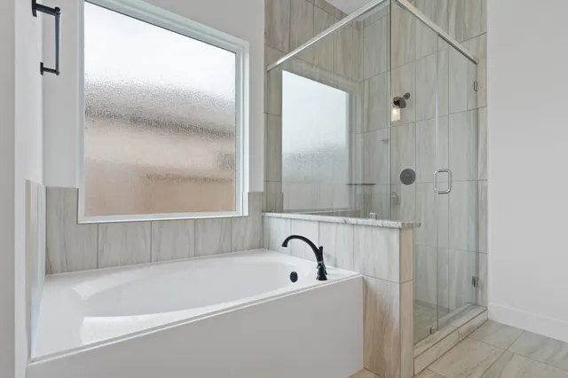 a bathroom with a bathtub and a shower