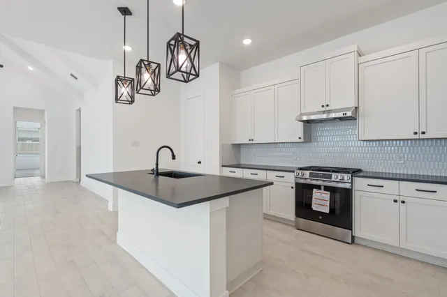 a kitchen with a sink and cabinets