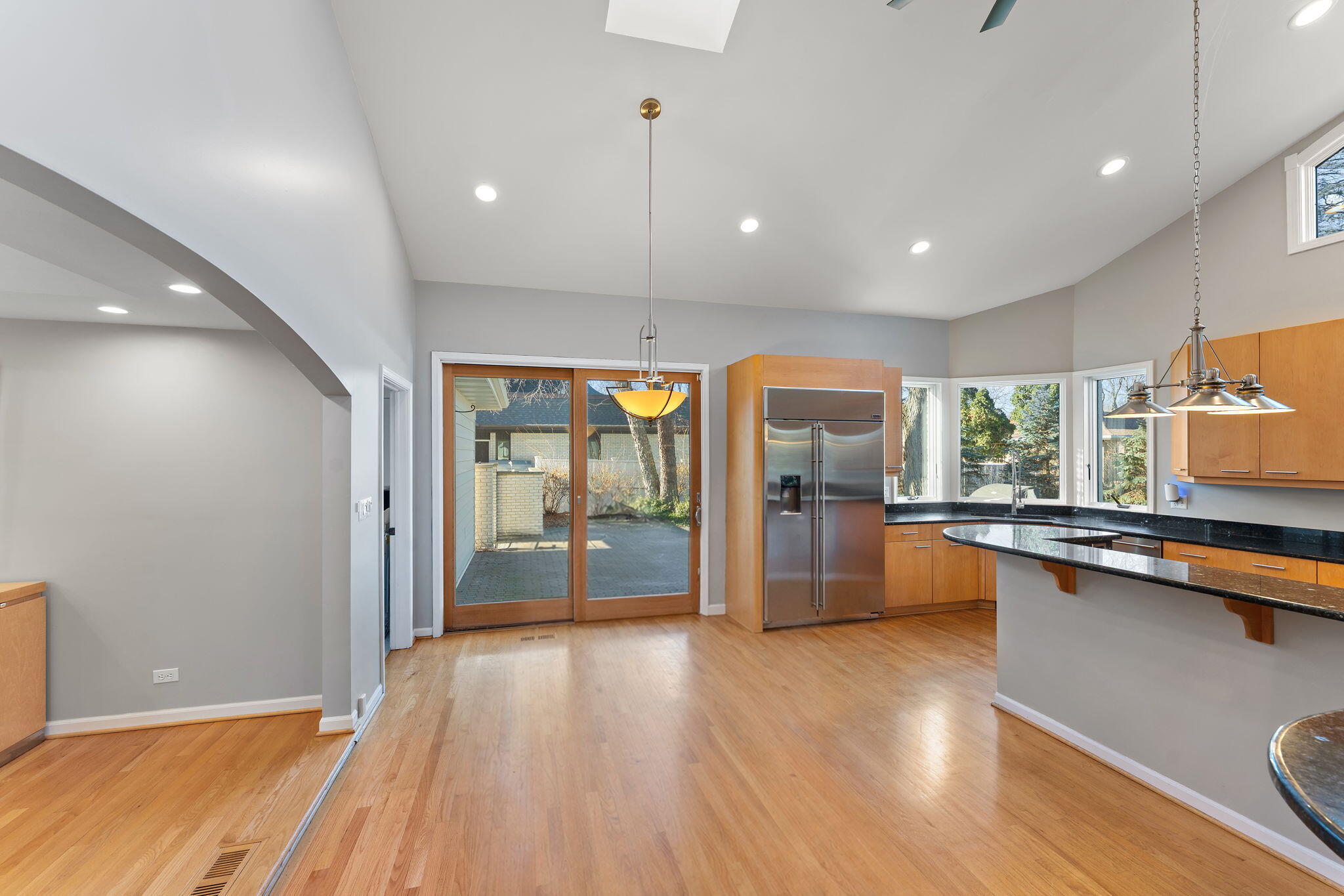 1841 Lambert Lane Munster, IN 46321 - Photo 11 of 66 a open kitchen with stainless steel appliances granite countertop a refrigerator a sink and a stove with wooden floor
