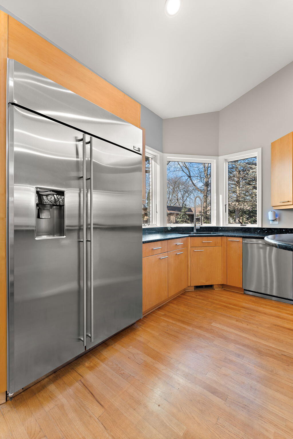 1841 Lambert Lane Munster, IN 46321 - Photo 22 of 66 a large kitchen with granite countertop a refrigerator and a sink