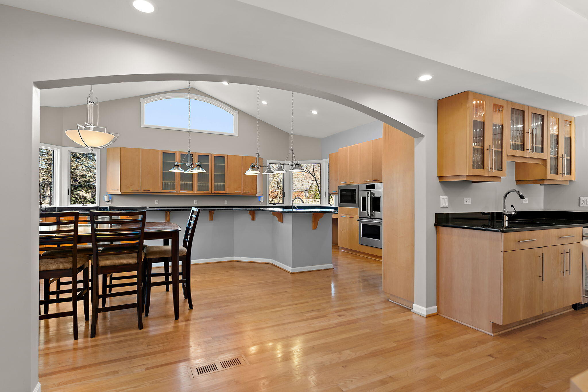 1841 Lambert Lane Munster, IN 46321 - Photo 26 of 66 a kitchen with stainless steel appliances granite countertop a table chairs and a wooden floor
