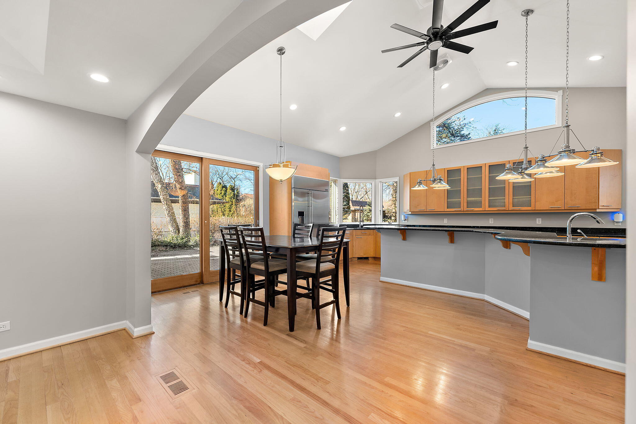 1841 Lambert Lane Munster, IN 46321 - Photo 27 of 66 a kitchen with stainless steel appliances granite countertop a stove top oven a dining table and chairs with wooden floor