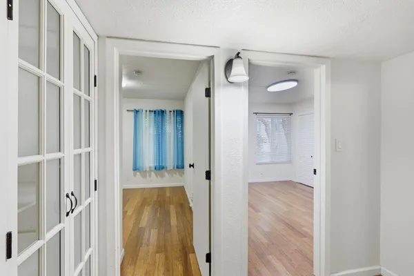 a view of a room with wooden floor