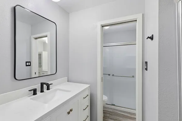 a bathroom with a toilet sink and mirror