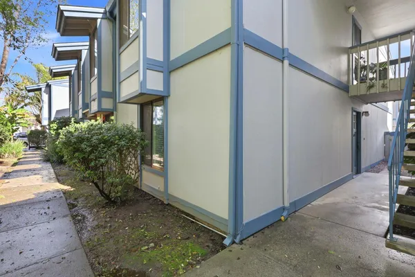 a view of a building with plants and entryway