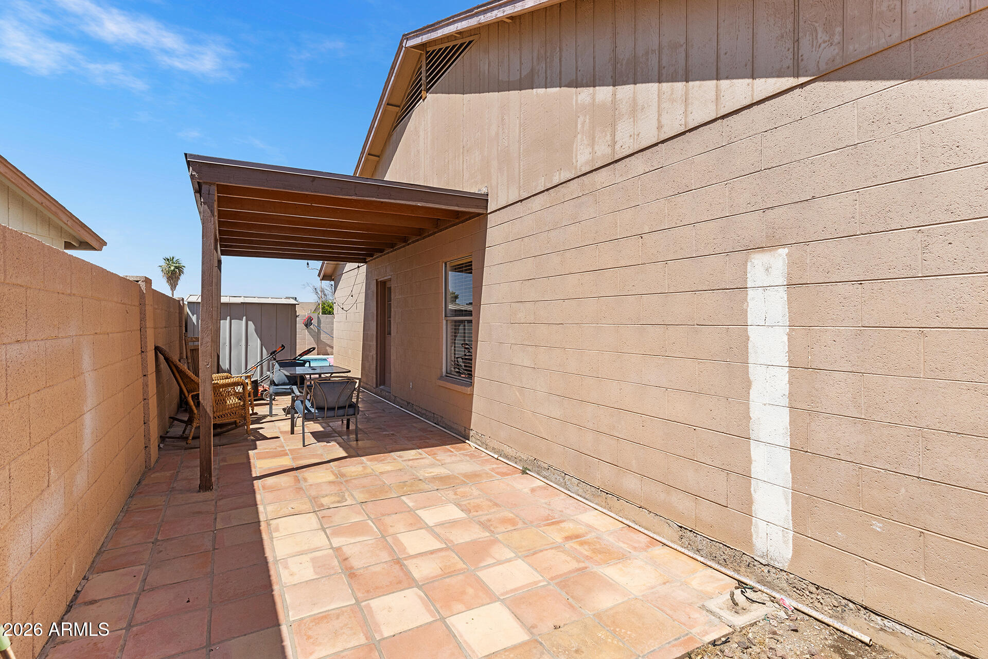 9002 West Coronado Road Phoenix, AZ 85037 - Photo 42 of 54 a patio with glass top table and chairs